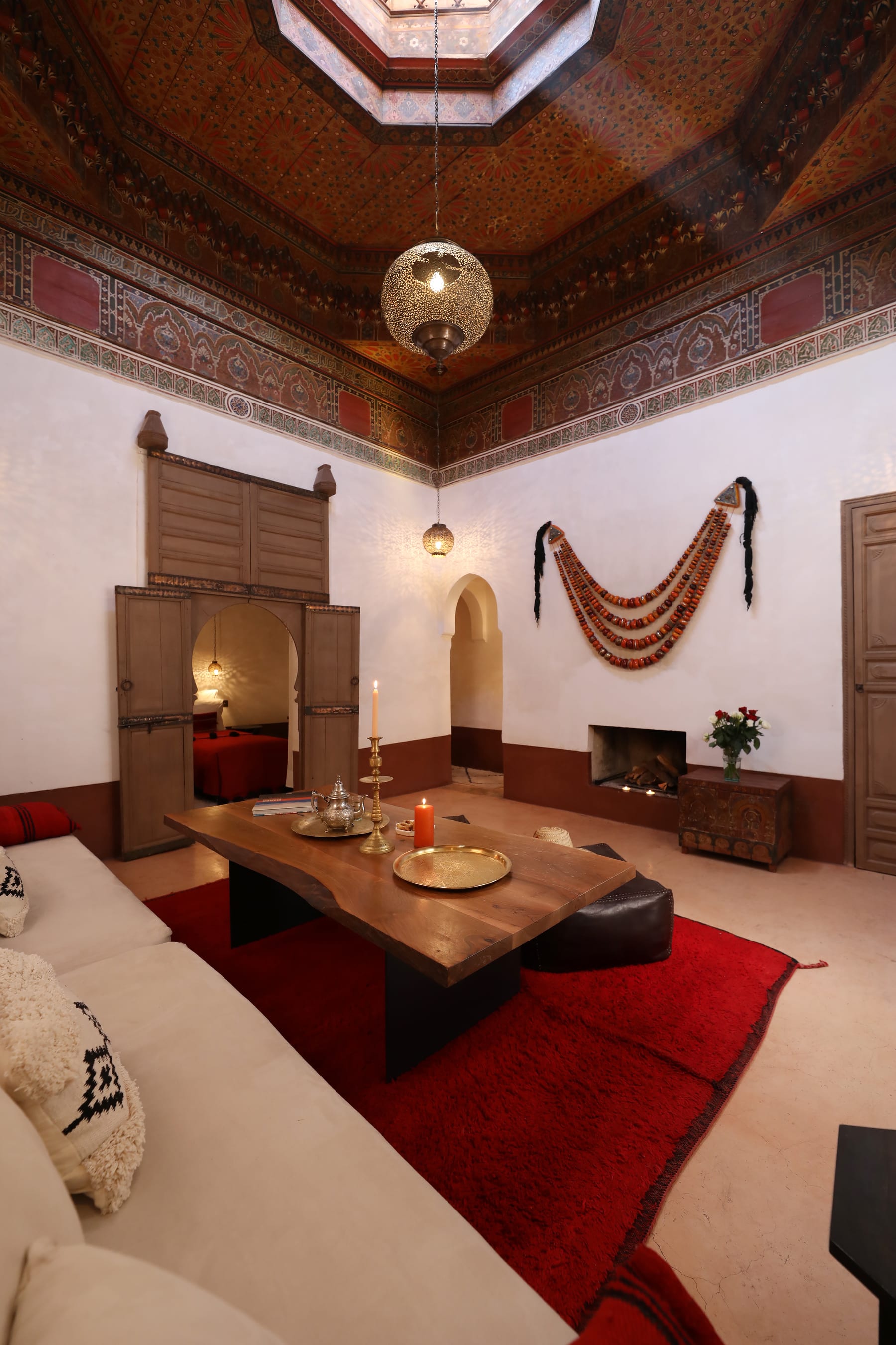 The red sitting room and painted ceiling of the Douiria Suite